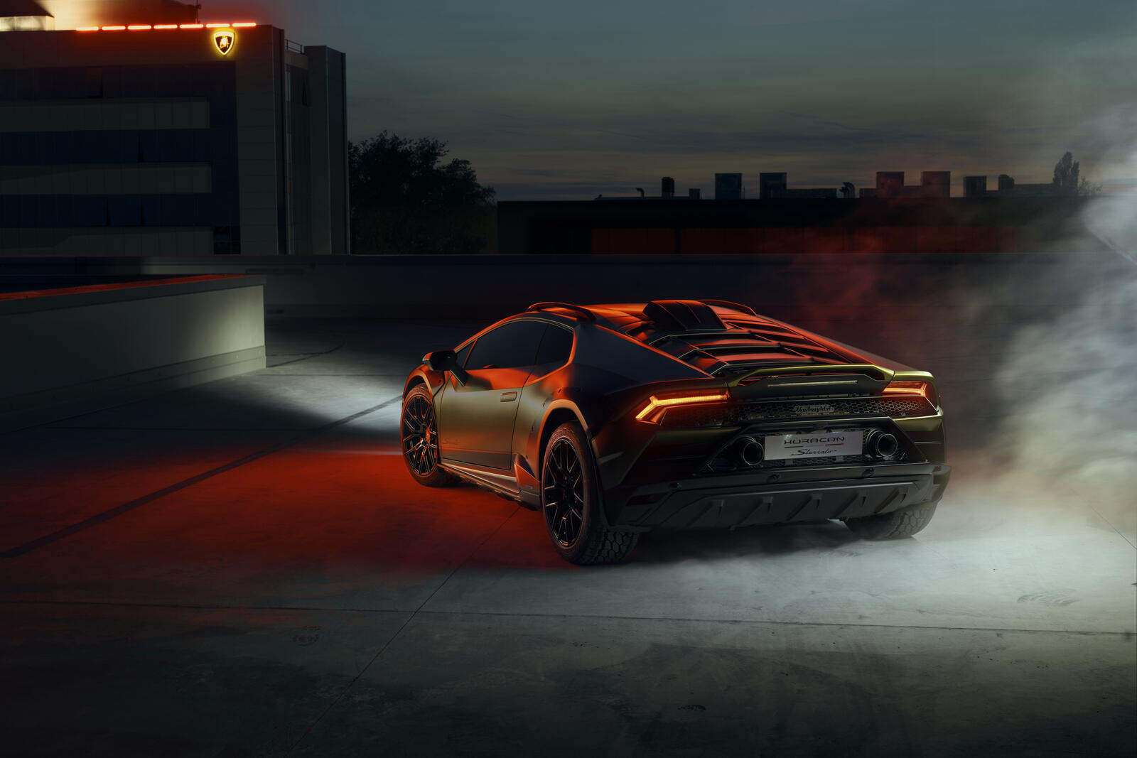 Free photo Black matte Lamborghini Huracan with rear lights on