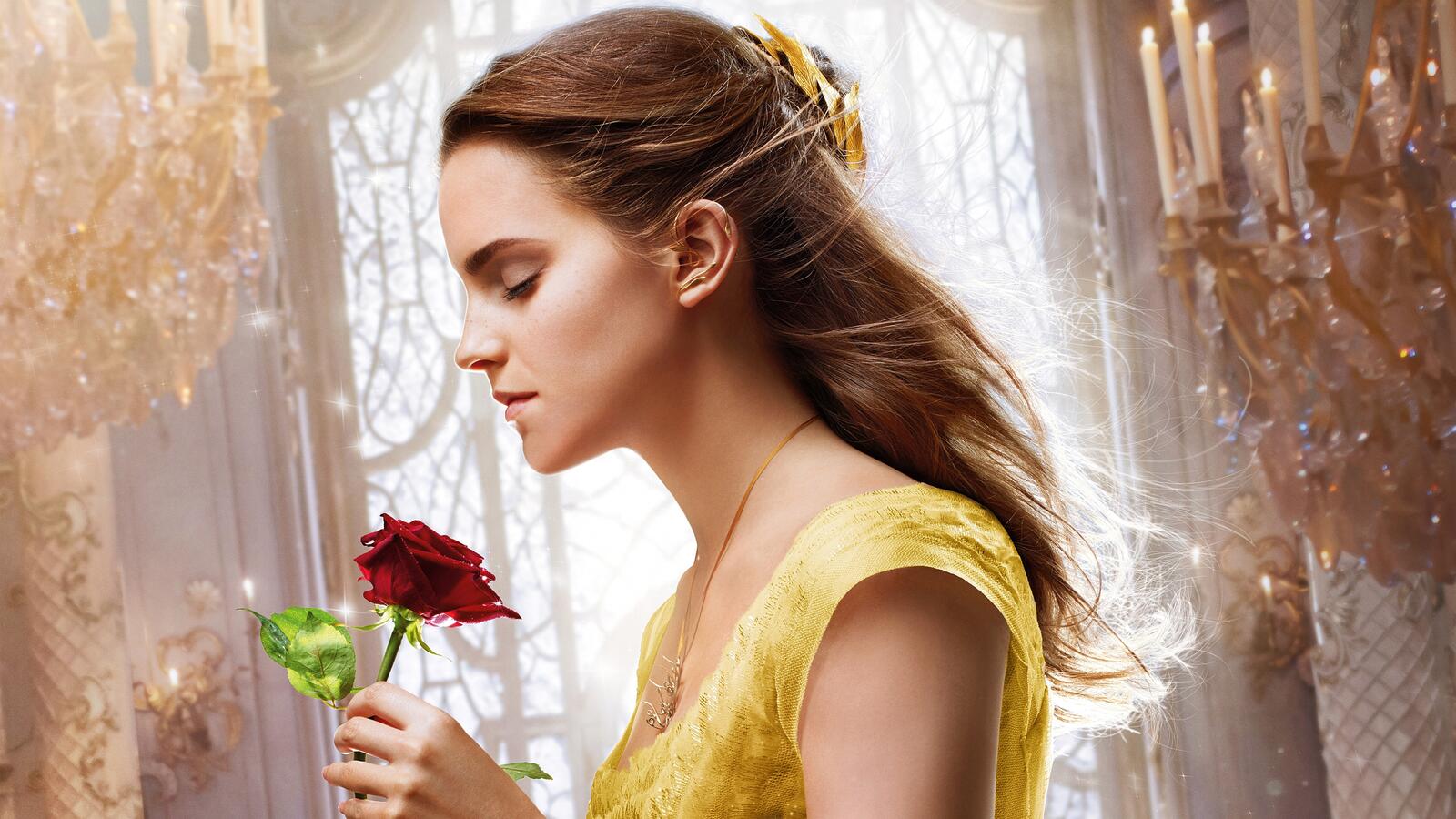 Free photo Emma Watson with a red rose in her hands