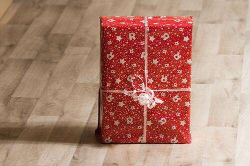 New Year`s gift wrapped in red paper