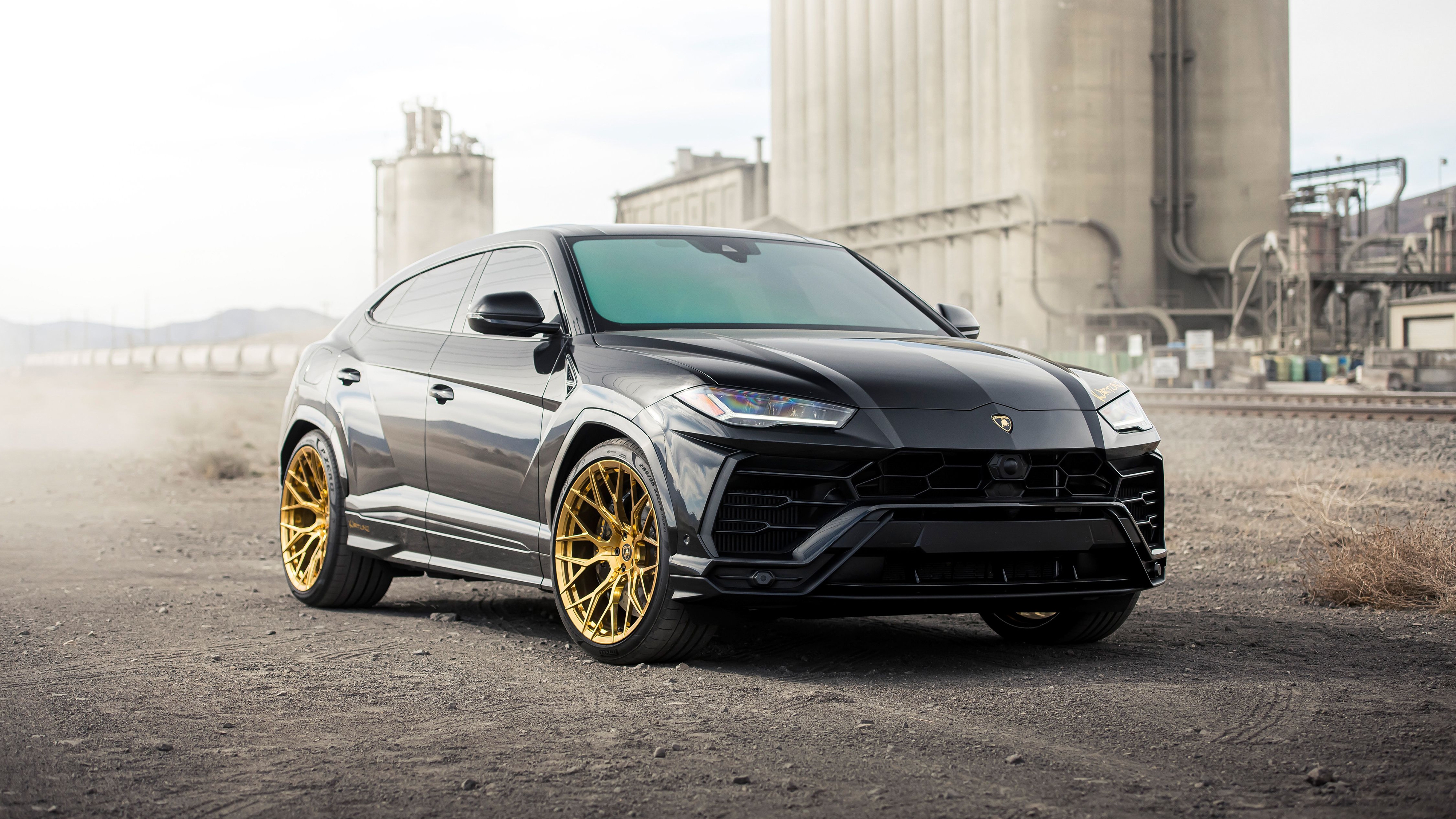 Black Lamborghini Urus on gold rims