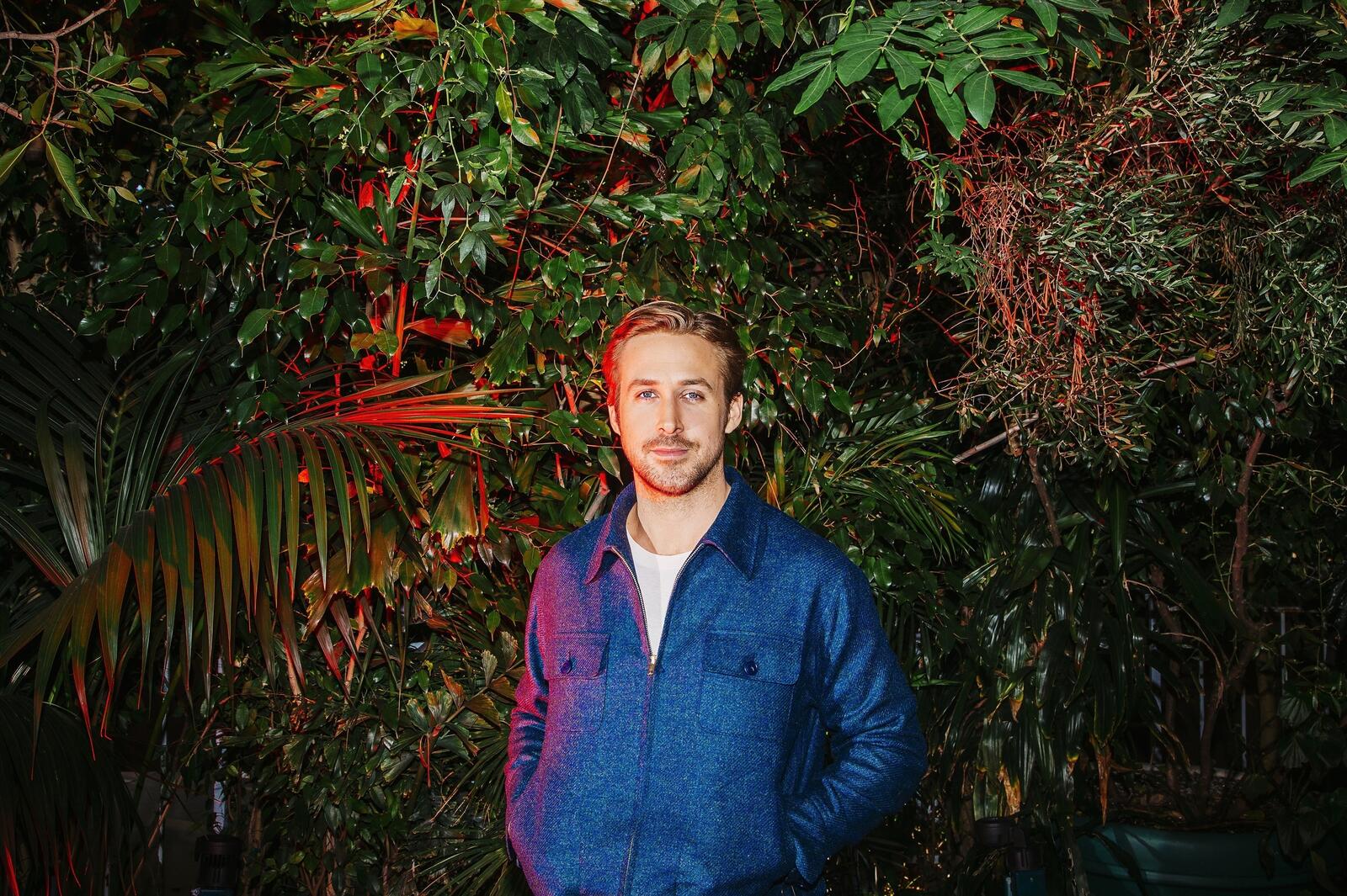 Free photo Ryan Gosling is photographed against a backdrop of plants