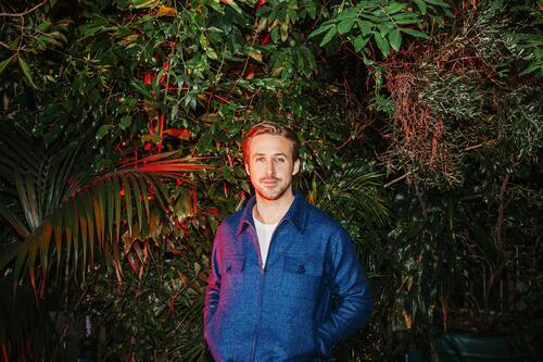 Ryan Gosling is photographed against a backdrop of plants