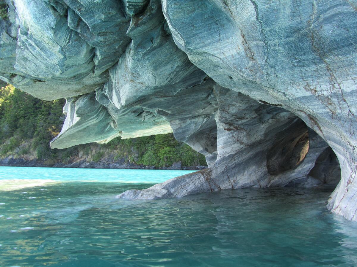 A flooded cave by the blue water of the sea