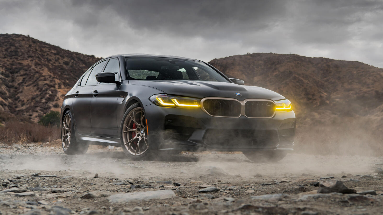 Free photo A bmw m5 f90 is parked in a dusty quarry.