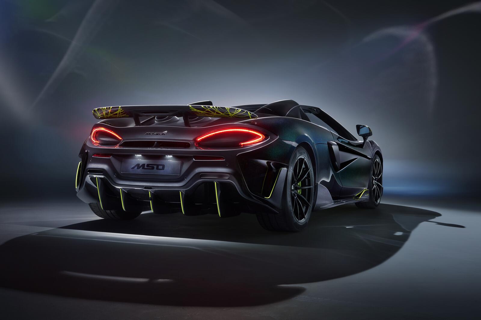 Free photo Black Mclaren 600LT rear view with lights on