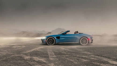 Aston Martin Vantage in a dusty quarry.