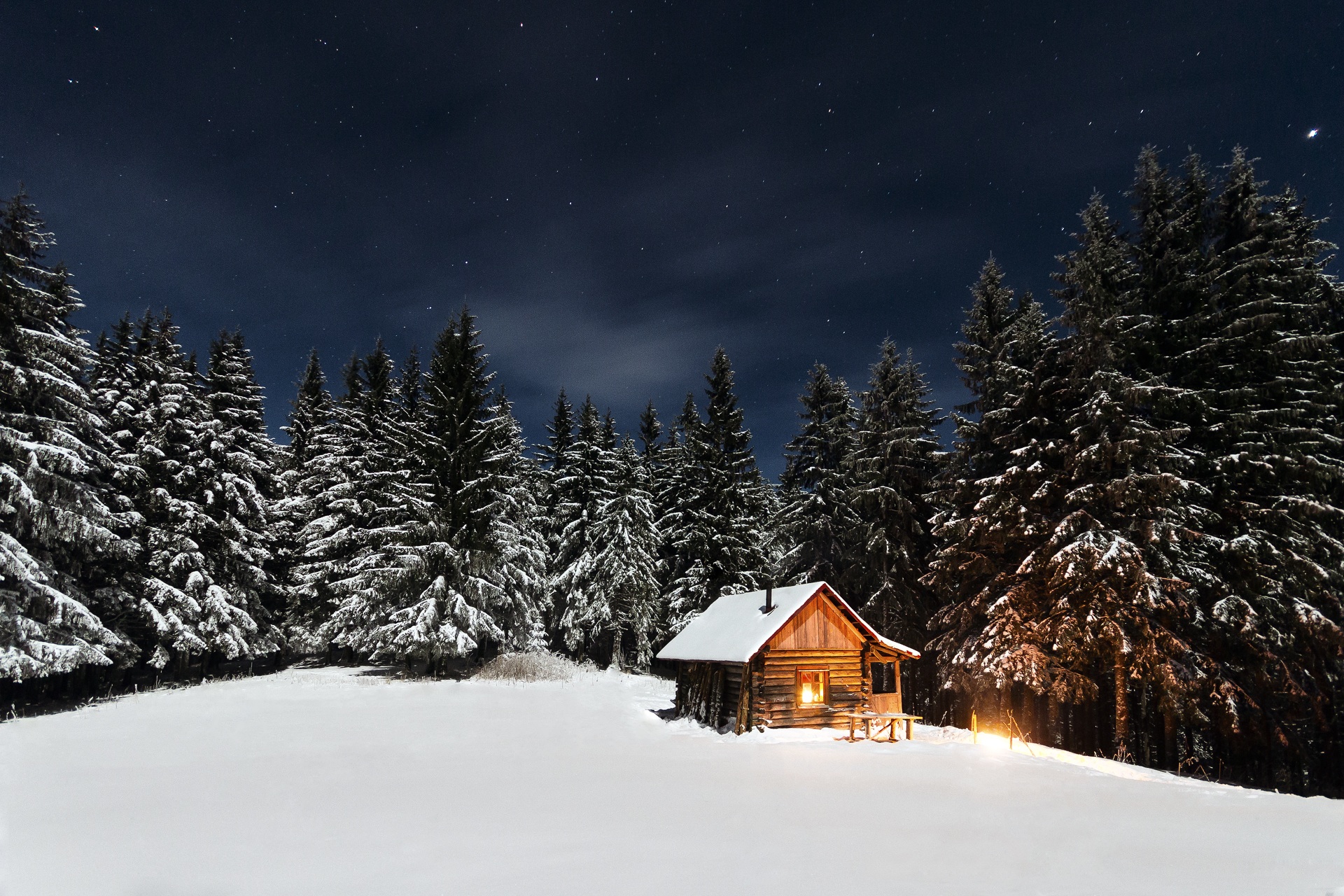 Wooden cabin in the woods in winter