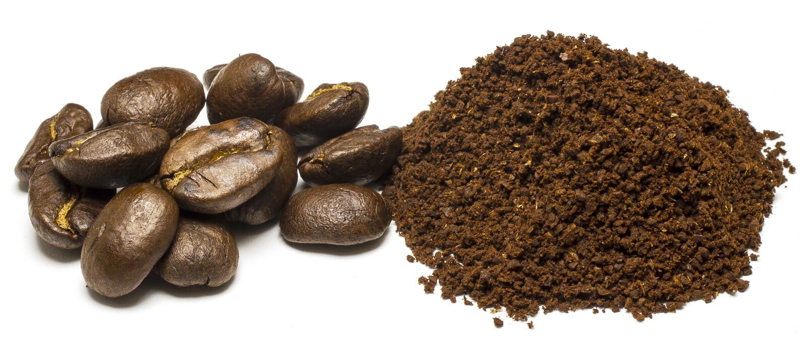 Free photo Coffee beans with a pile of coffee dust on a white background
