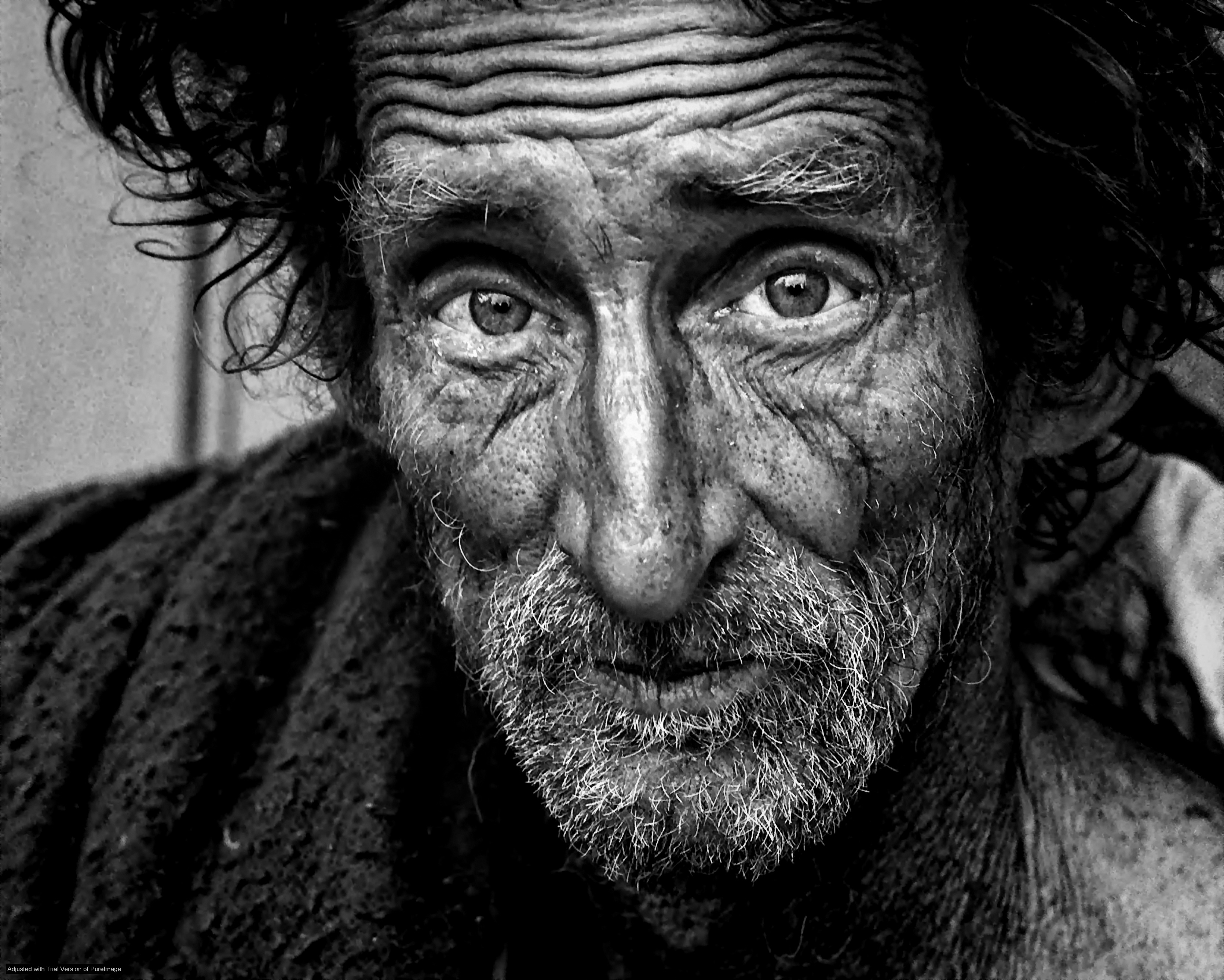 Portrait of an old homeless man