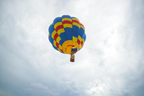 A balloon into the sky with clouds