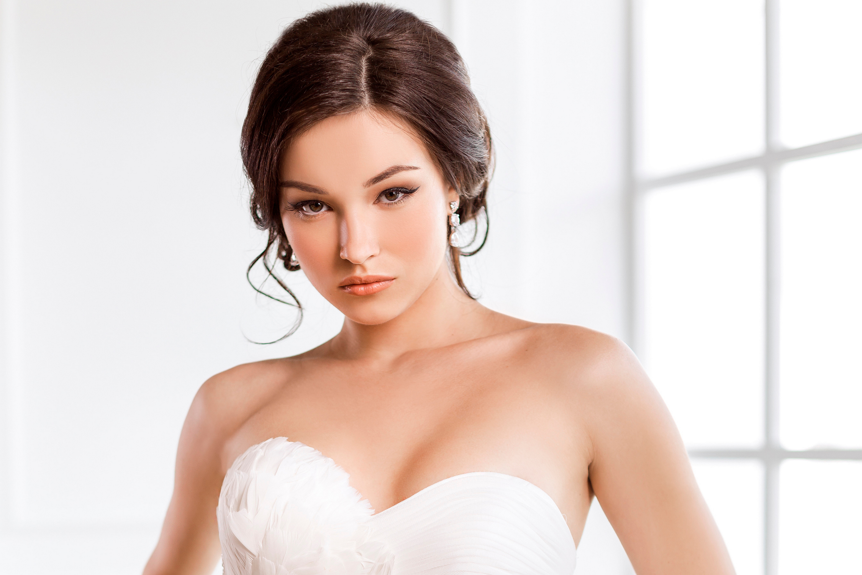 Portrait of a brunette in a white wedding dress