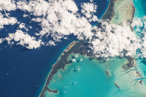 Вид с космоса на остров окруженный разными морями