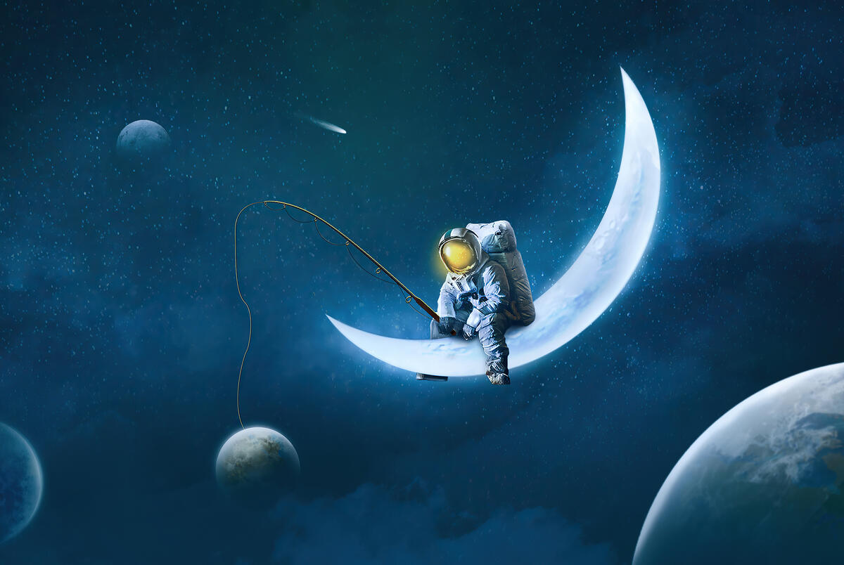 The astronaut is fishing from a crescent moon.