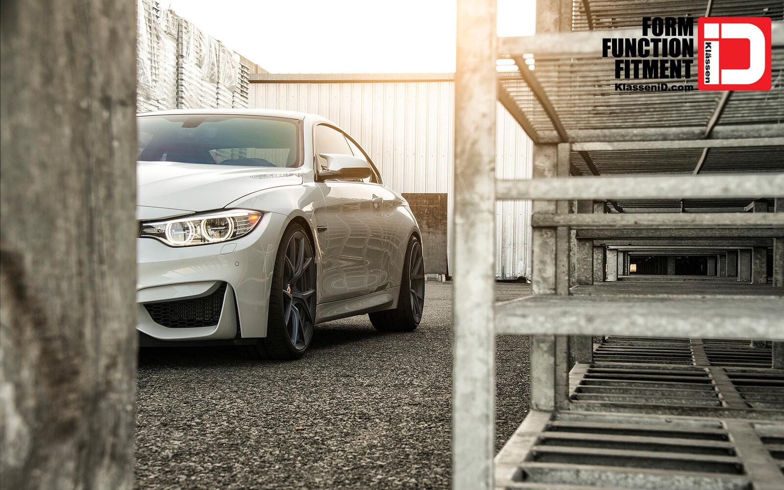 Free photo A white BMW M4 peeks out from around the corner.
