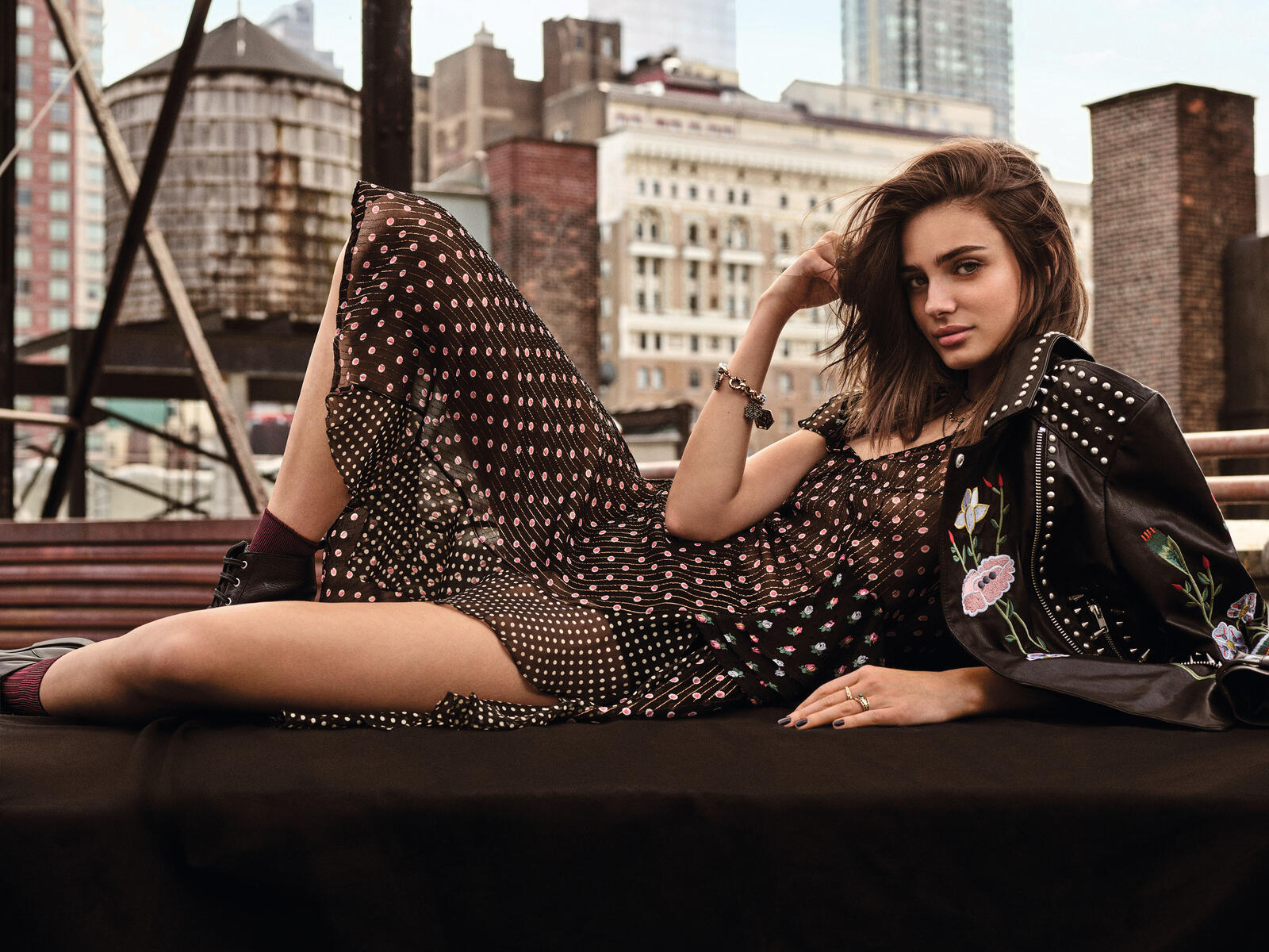 Free photo Taylor Hill lying down posing in front of the city