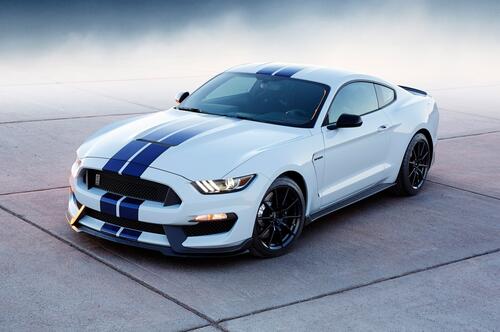 Luxury Ford Mustang in white with blue stripes.