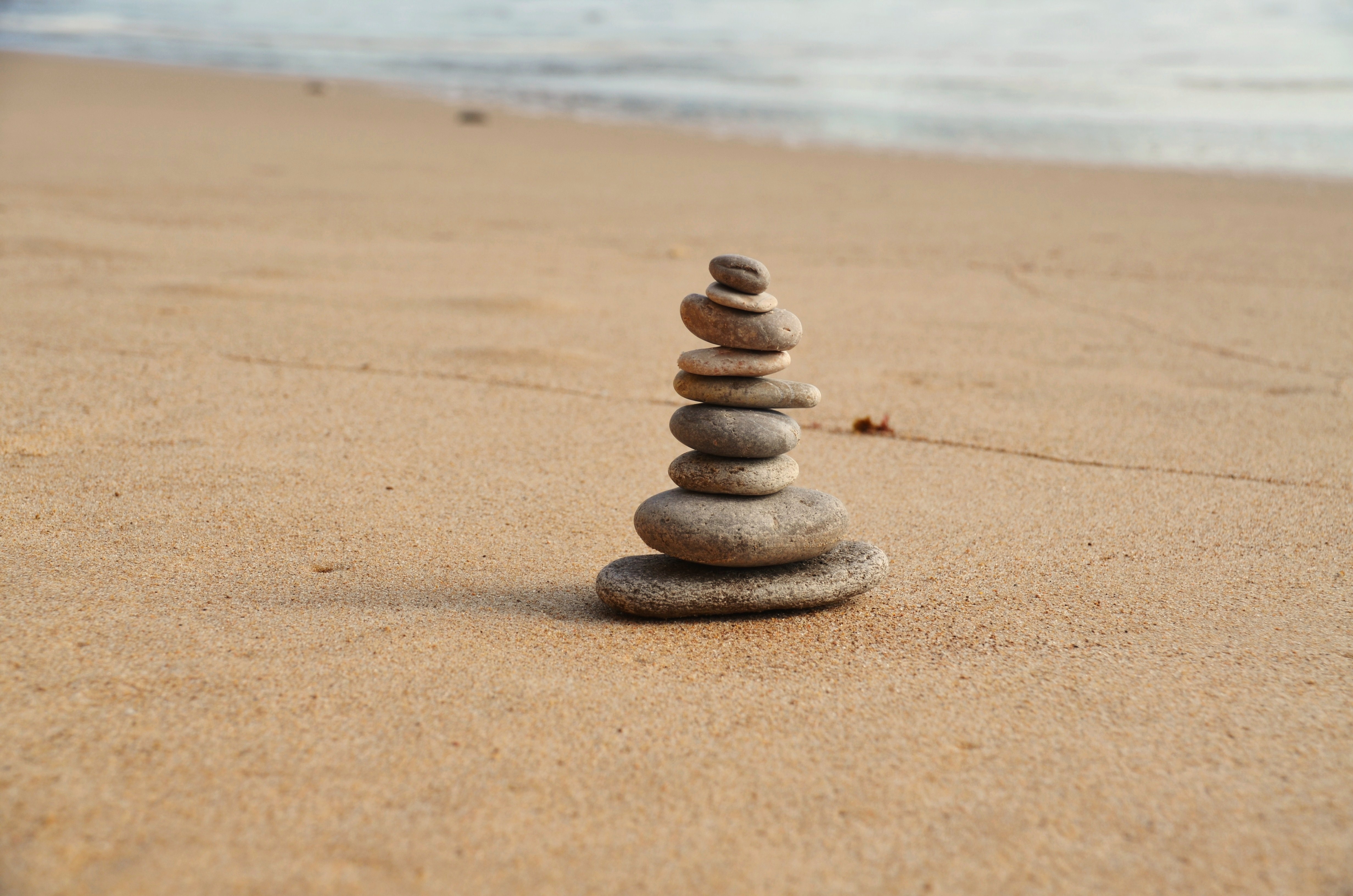 A pyramid of pebbles on a sandy beach