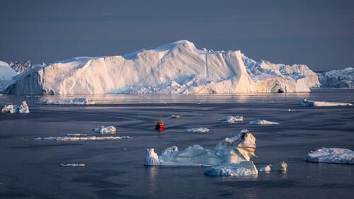 A floating ship near icebergs