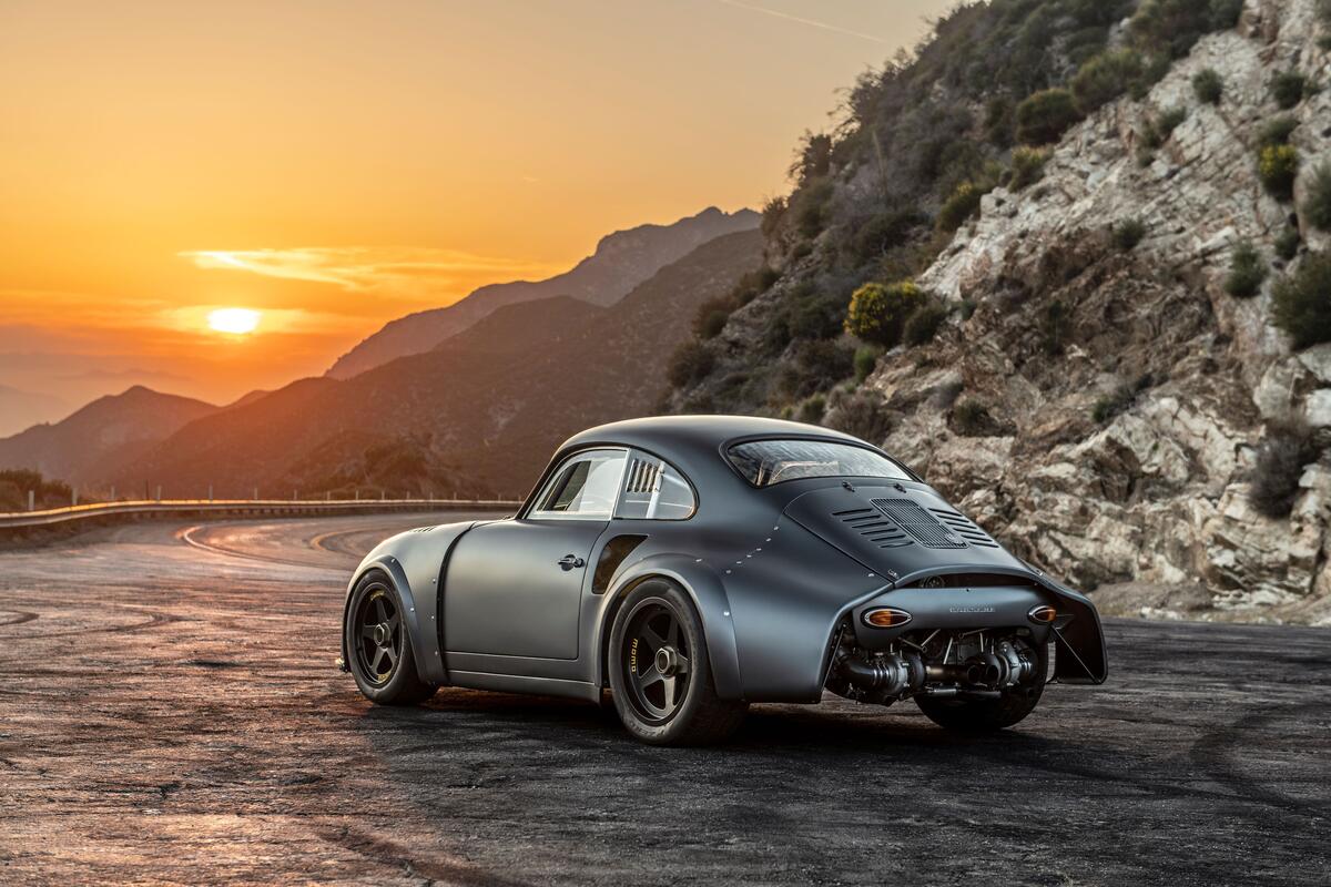 A vintage matte gray Porsche at sunset