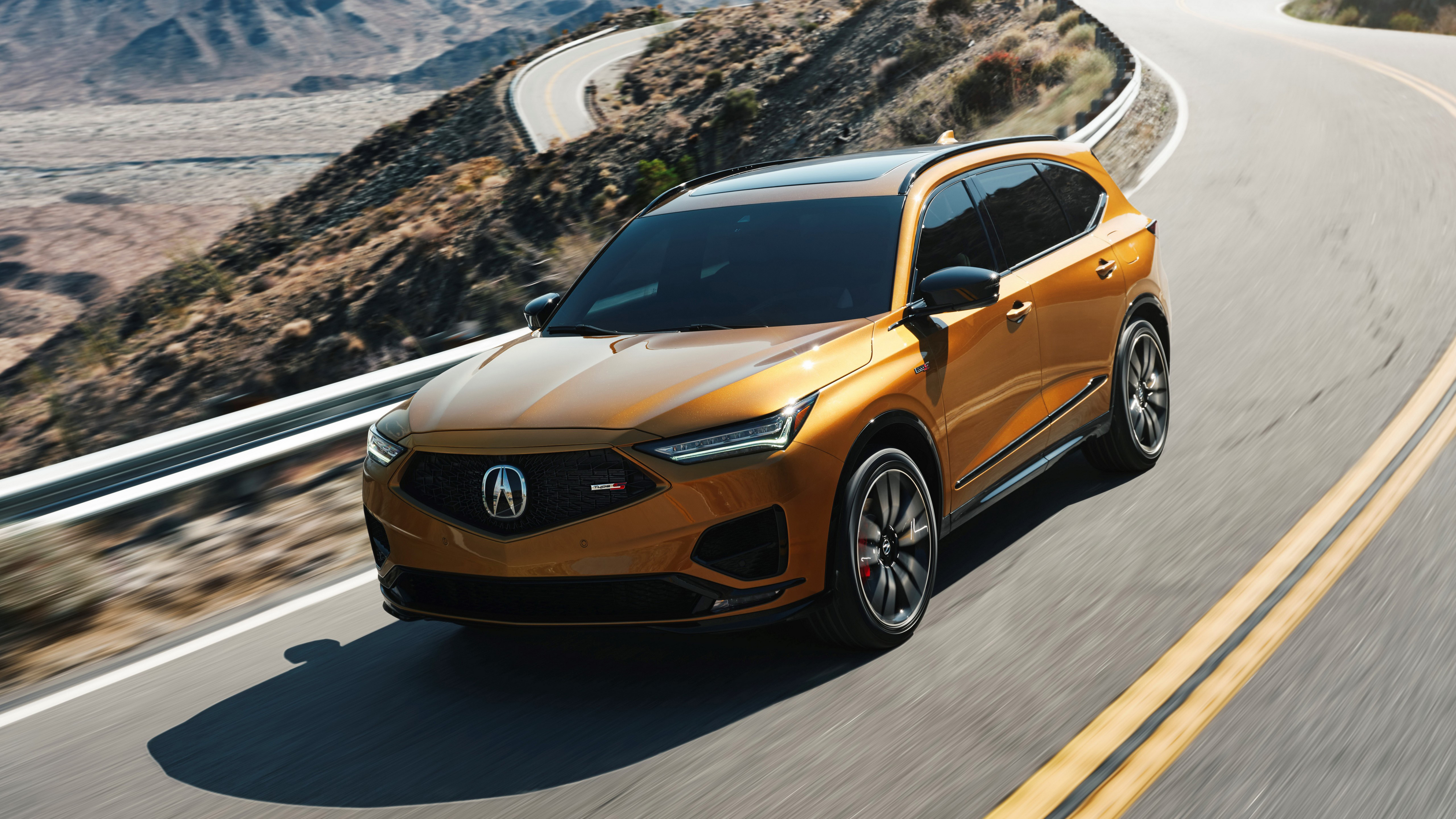 The acura mdx 2022 SUV drives on a country road