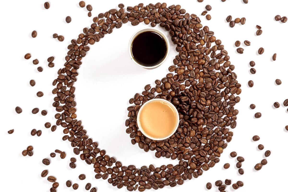 Coffee and coffee beans on a white background in the form of Yin Yang
