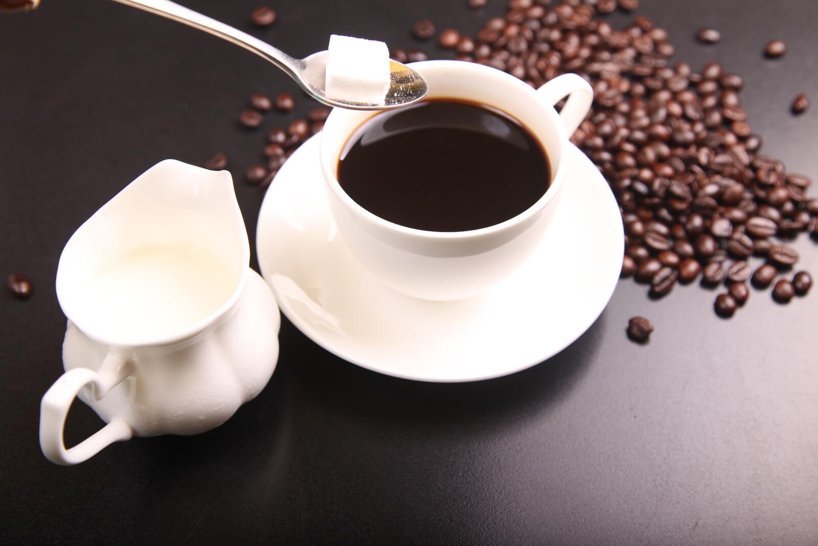 Бесплатное фото Чашка кофе с кубиком сахара