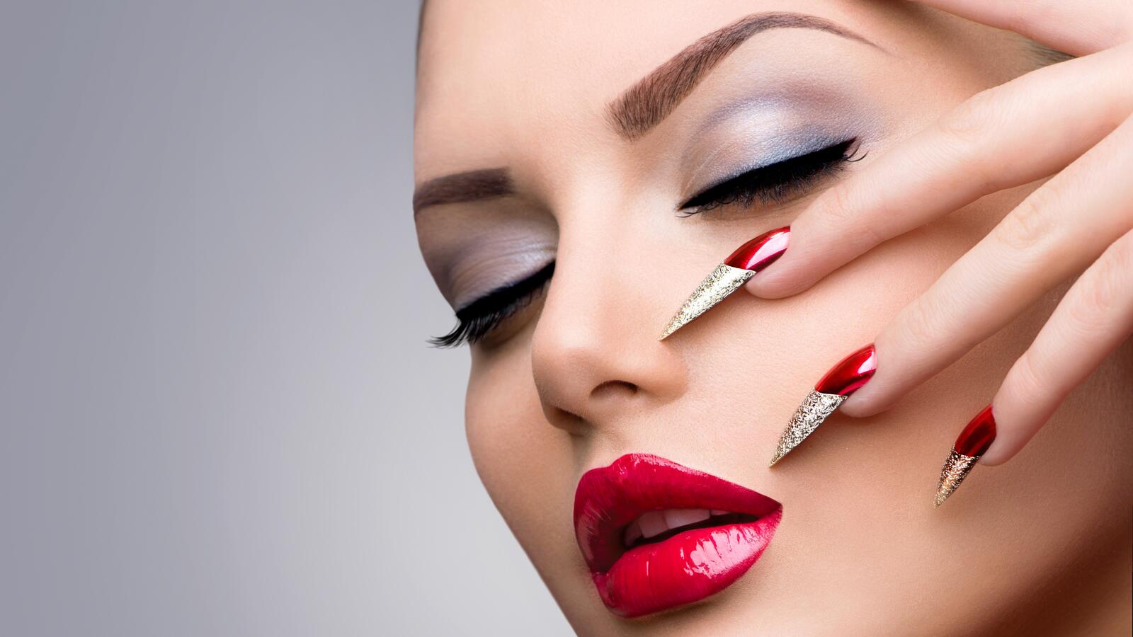 Free photo Model shows beautiful makeup and red manicure