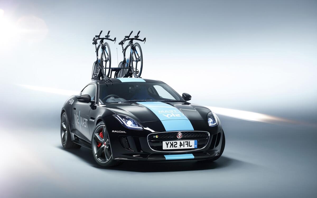 Sporty Jaguar with bicycles on the roof