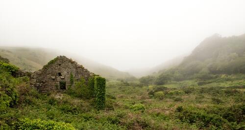 Ruins of a stone house in the valley of the hill