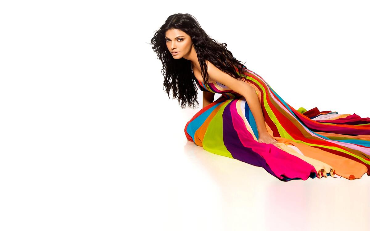 Indian celebrity Sherlyn Chopra in a colored dress on a white background
