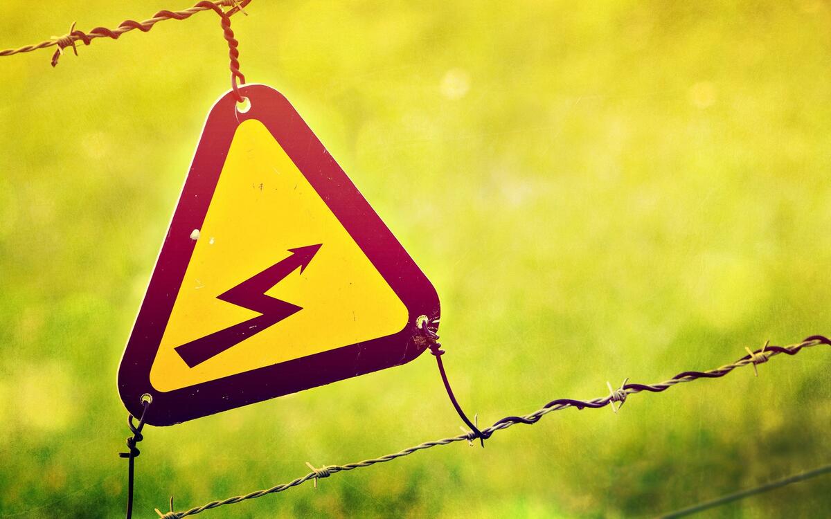 High voltage sign on barbed wire