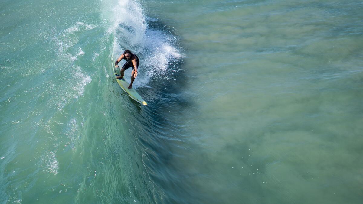 A surfer conquers a small wave