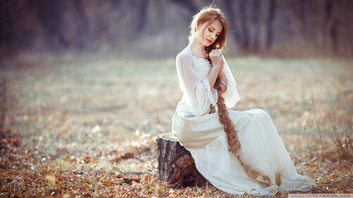 A girl in a white dress with a long braid.