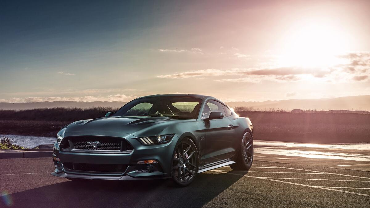 A green Ford Mustang on a sunny day
