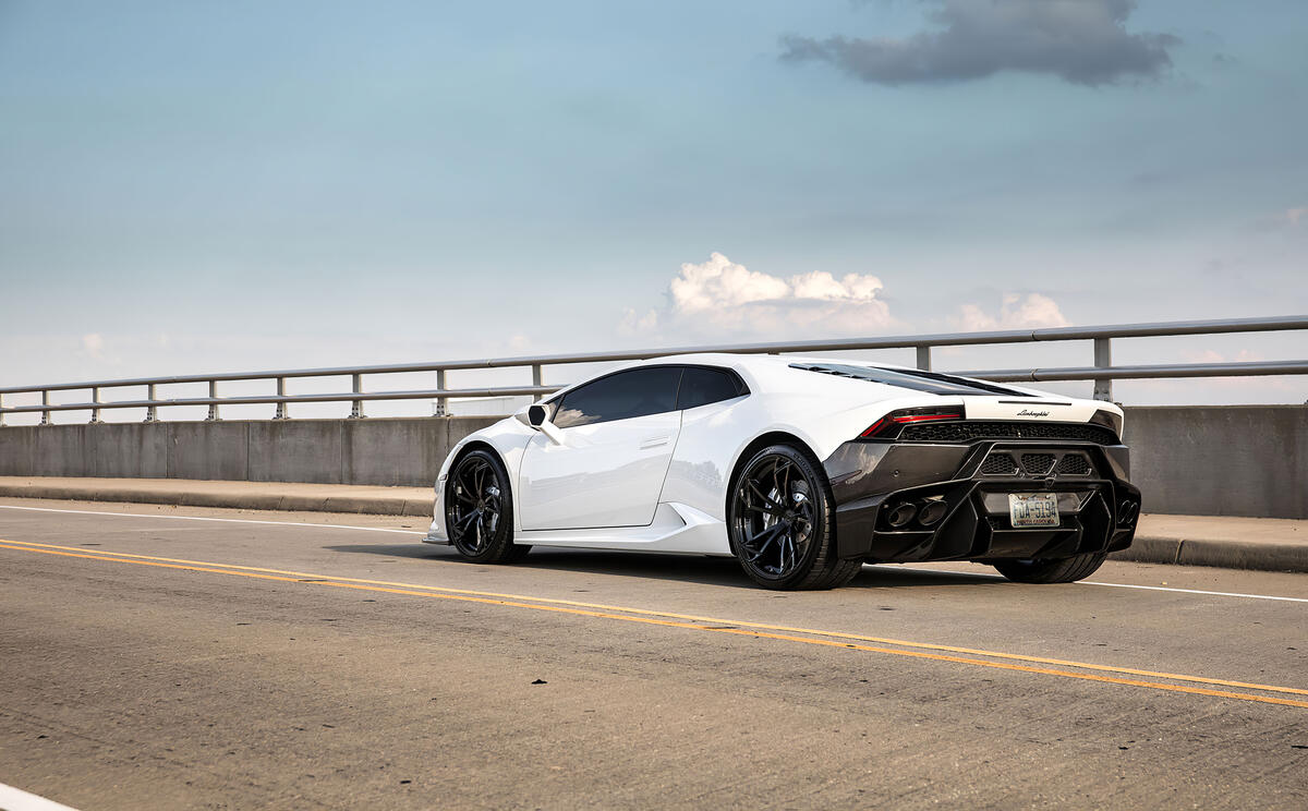White Lamborghini Huracan with black rims photographed from behind