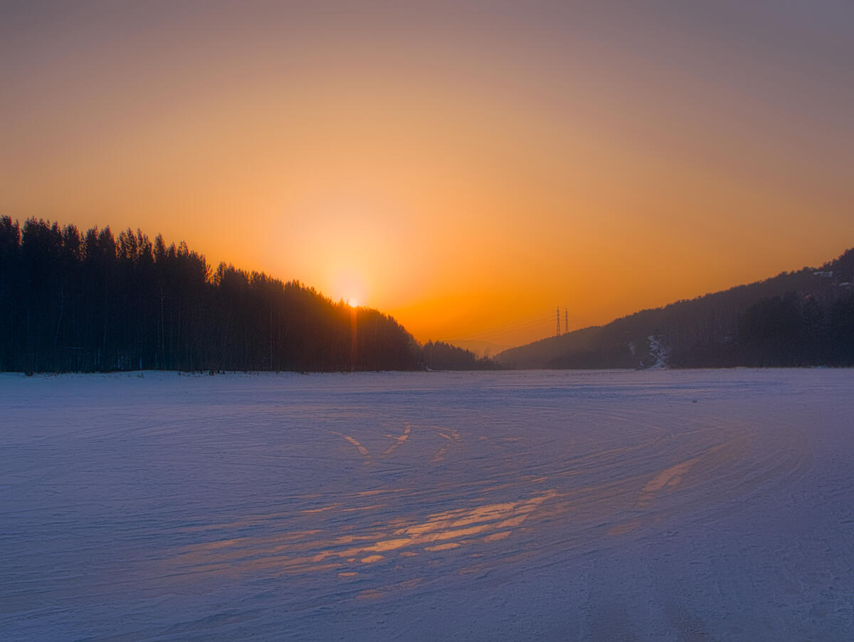 Sunset over the frozen river