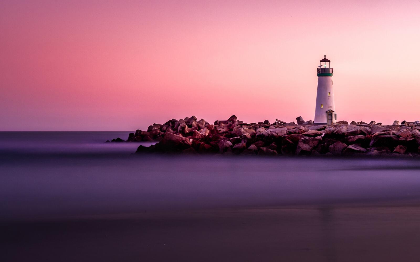 Free photo Wallpaper with a lighthouse on the ocean coast