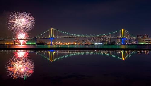 Night Bridge in Japan with a festive fireworks display