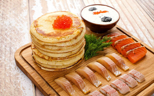 Breakfast with pancakes and fresh fish