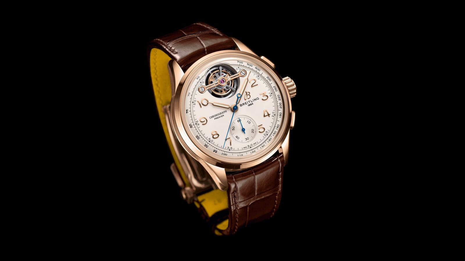 Free photo Breitling watch in gold on a dark background