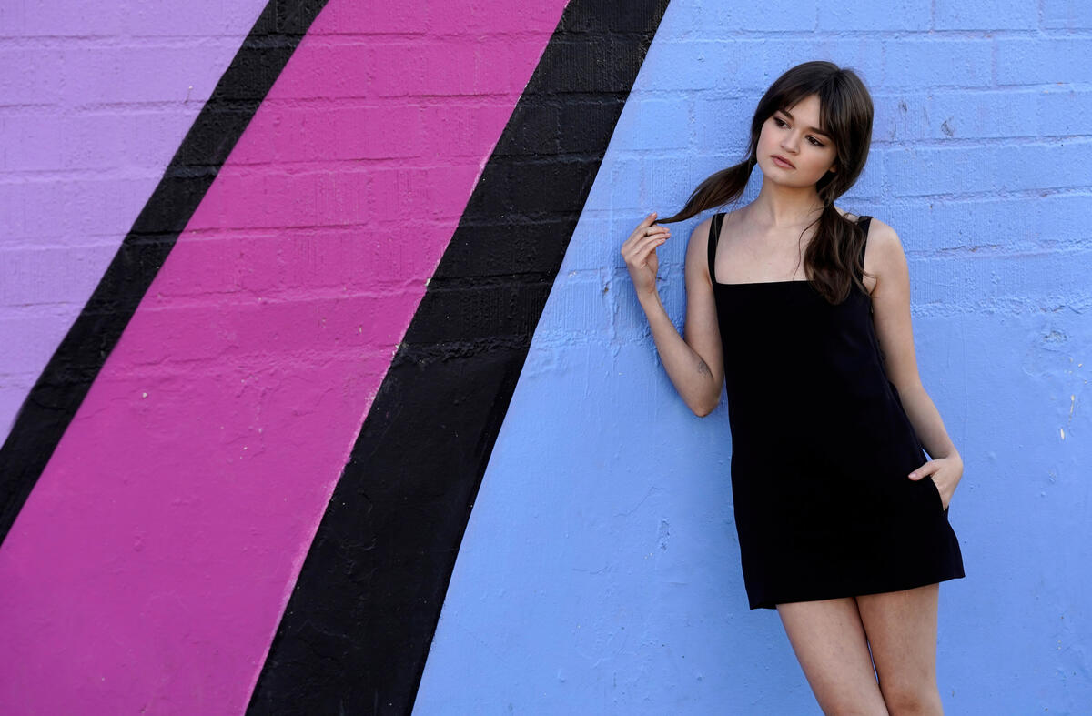 Ciera Bravo stands at the wall with graffiti drawings