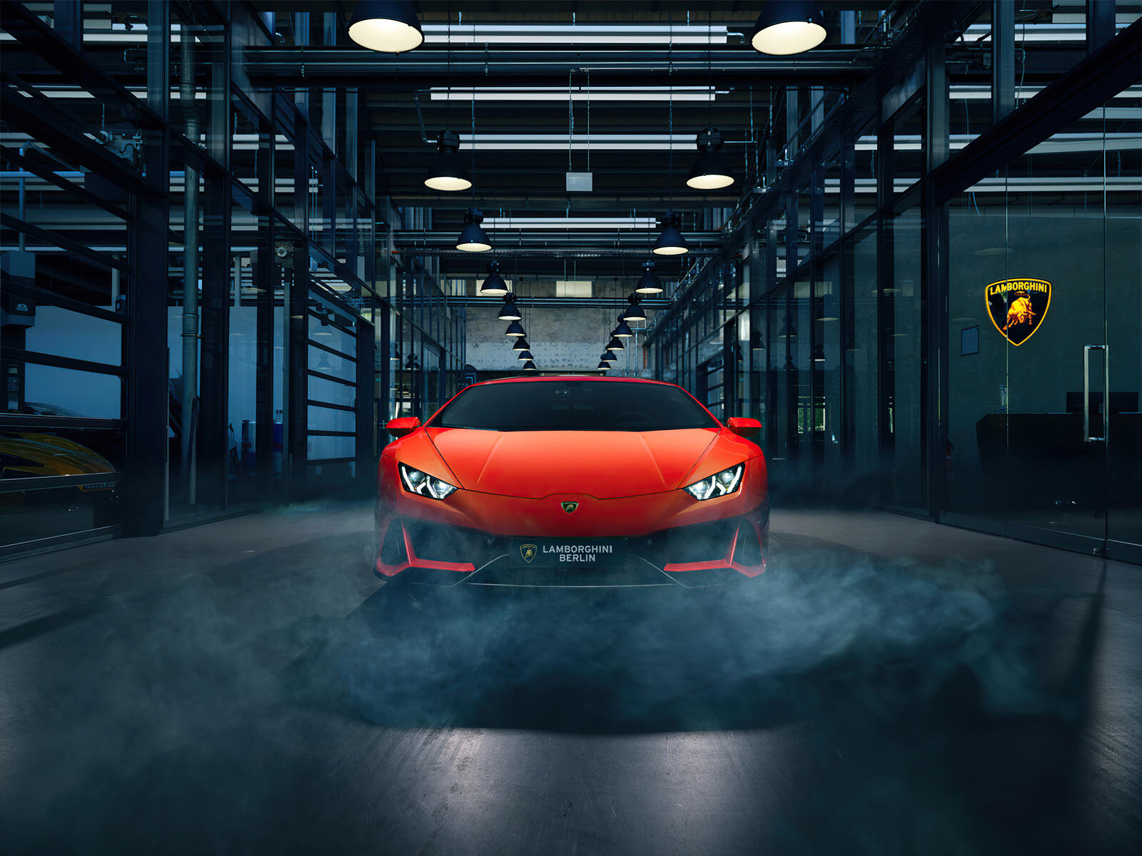 Free photo A red Lamborghini in a smoky room.
