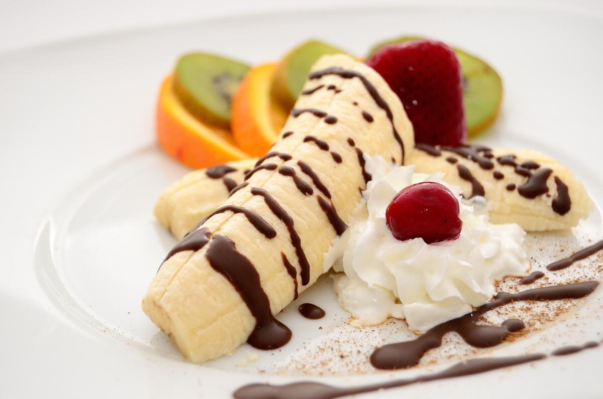 Delicious dessert made of fruits with chocolate syrup