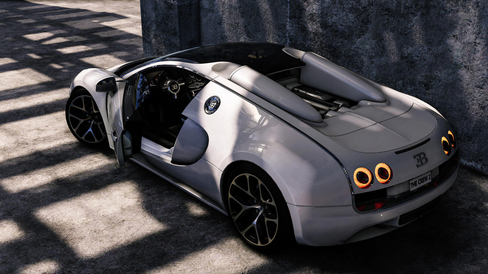 Free photo White Bugatti Veyron rear view with lights on