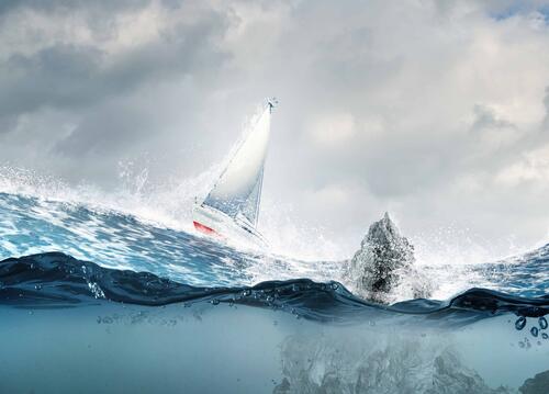 A sailboat drifts in the Arctic off the Iceberg.