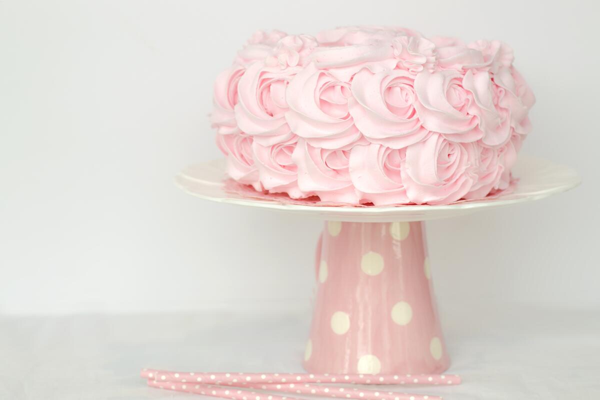 Delicious cake decorated with cream in the form of roses