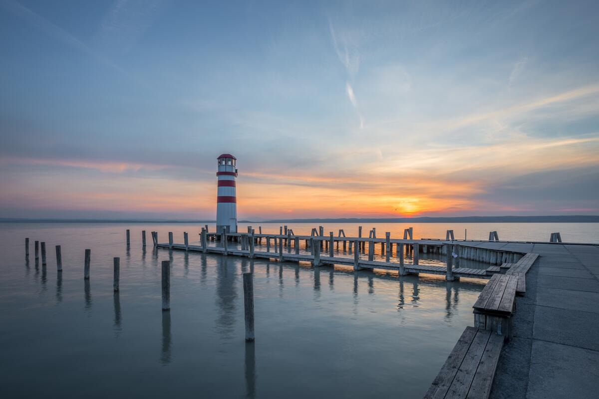Lighthouse on the beach with a pier