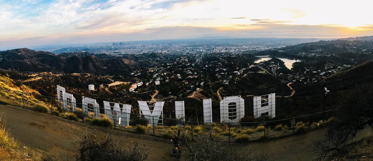 A large cityscape on the side of the letters hollywood