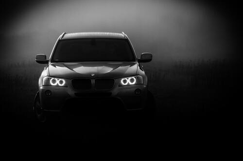 BMW X3 with lights on in the fog