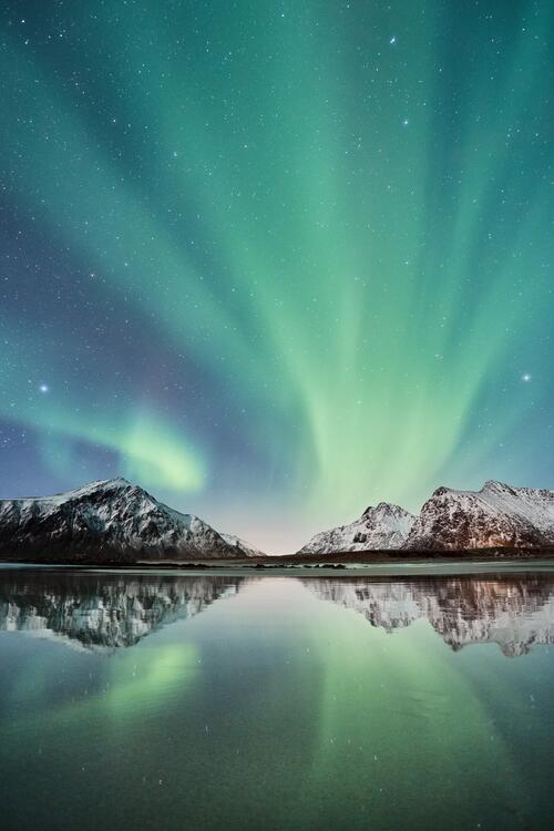 Northern Lights over the lake during daylight hours